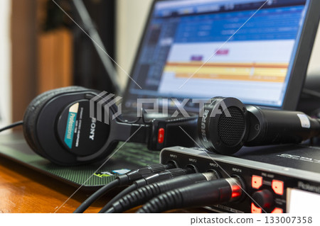 recording equipment in a studio. Microphone, sound card, computer, headphones. Close-up 133007358