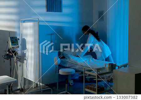 Preparing sterile medical workstation, Clean environment arranged for patient treatment, Healthcare worker systematically arranging equipment in sterile room 133007382