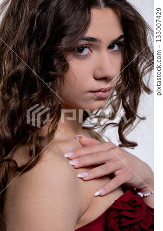 An Elegant and Stunning Portrait of a Young Woman with Bouncy, Curly Hair Styling An Elegant and Stunning Portrait of a Young Woman with Bouncy, Curly Hair Styling 133007429