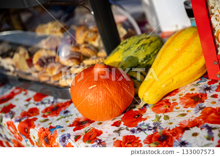 A Vibrant Display of Colorful Fall Vegetables and Delicious Baked Goods at the Market Stall 133007573