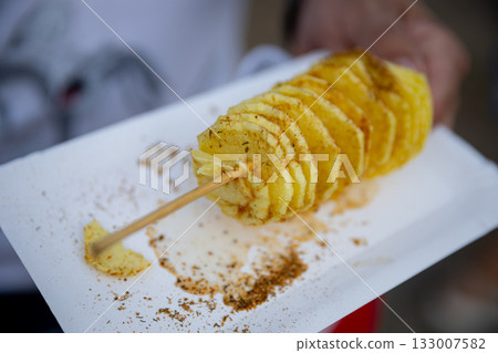 Indulge in the flavorpacked and deliciously spicy Tornado Potato served on a stick Indulge in the flavorpacked and deliciously spicy Tornado Potato served on a stick 133007582