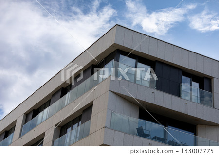 Modern Architectural Design Features Stunning Glass Balconies with Beautiful Clear Skies Modern Architectural Design Features Stunning Glass Balconies with Beautiful Clear Skies 133007775