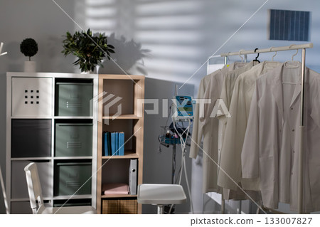 A Bright and Minimalist Medical Office Featuring White Lab Coats for a Clean, Welcoming Atmosphere A Bright and Minimalist Medical Office Featuring White Lab Coats for a Clean, Welcoming Atmosphere 133007827