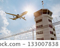 Air Traffic Control Tower at Airport As Airplane Takes Off. 133007838