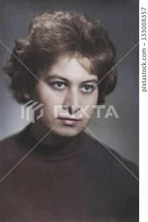 A vintage portrait of a young, attractive brunette with a beautiful 1960s-style hairstyle. Retro photo from 1965. A vintage portrait of a young, attractive brunette with a beautiful 1960s-style hairstyle. Retro photo from 1965. 133008357