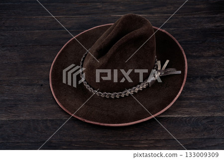 Old west hat on table. 133009309
