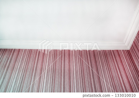White ceiling and pink striped wallpaper with crown molding close up White ceiling and pink striped wallpaper with crown molding close up 133010010