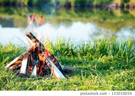 Burning fire on the shore of the reservoir. High quality photo Burning fire on the shore of the reservoir. High quality photo 133010050