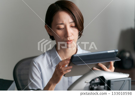 A woman checking the operation of a drone 133010598