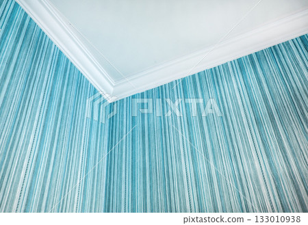 Room corner with white crown molding and teal striped wallpaper horizontal frame Room corner with white crown molding and teal striped wallpaper horizontal frame 133010938