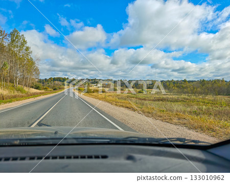Empty country road view from car autumn landscape with clouds horizontal frame 133010962