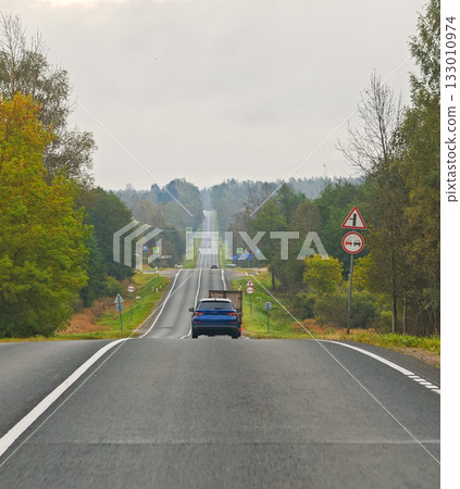 Country road view from car with truck and car autumn landscape horizontal frame Country road view from car with truck and car autumn landscape horizontal frame 133010974