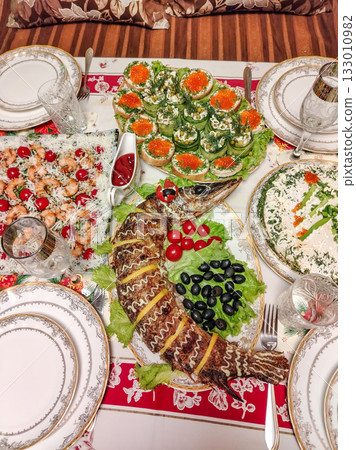 Festive home dinner table with caviar and shrimp elegant table setting vertical frame Festive home dinner table with caviar and shrimp elegant table setting vertical frame 133010982