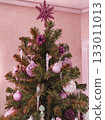 Christmas tree top with pink ornaments and pinecones close up 133011013