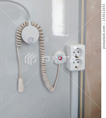 Vertical close up of a nurse call panel and outlet in a hospital room Vertical close up of a nurse call panel and outlet in a hospital room 133011033