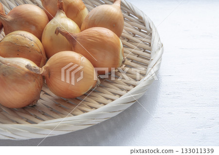 Small onions drying on a windowsill in winter 133011339
