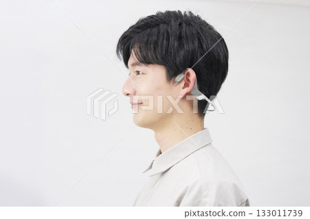 Male bone conduction earphones, 20s, white background Male bone conduction earphones, 20s, white background 133011739