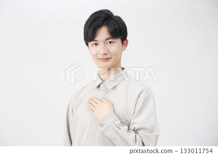 Man with hand on chest, 20s, white background, portrait 133011754