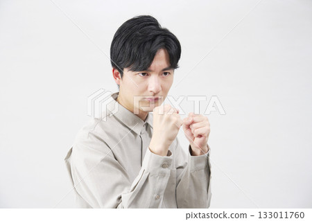 Man in his 20s fighting pose white background 133011760