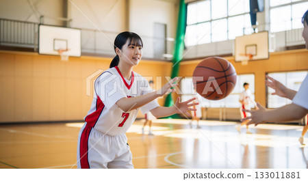 Female students practicing basketball in the gym Female students practicing basketball in the gym 133011881