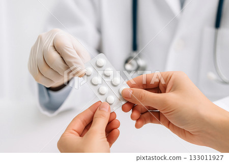 female doctor holding pills in hand female doctor holding pills in hand 133011927