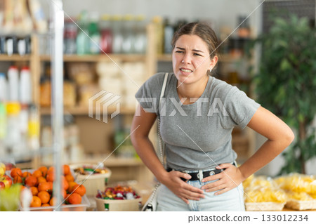 Young woman feels pain during menstruation 133012234