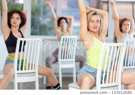 Women participant of dance group perform basic elements of heel dance in staggered manner. Development of female sexuality Women participant of dance group perform basic elements of heel dance in staggered manner. Development of female sexuality 133012686