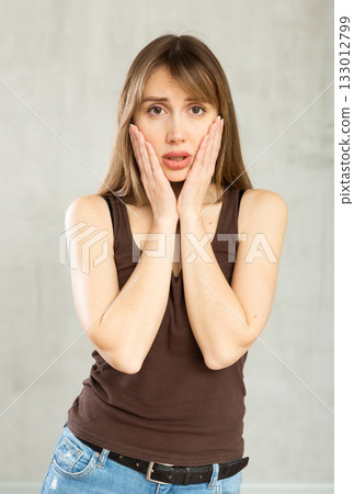 Young troubled woman with sad and worried expression on her face Young troubled woman with sad and worried expression on her face 133012799