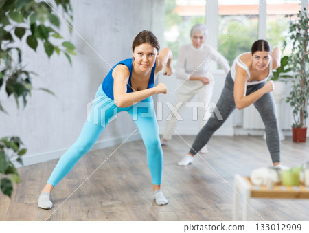 Positive women engaged in active dancing 133012909