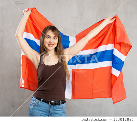 Young cheerful woman holding Norway flag Young cheerful woman holding Norway flag 133012985