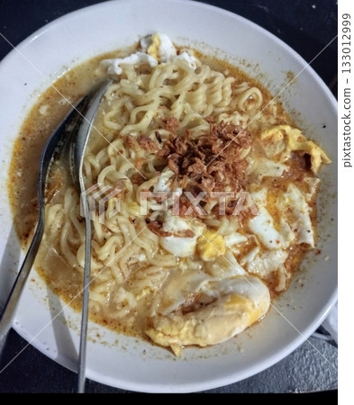 Delicious Indomie kuah with rich, savory broth and springy noodles, creating a warm and comforting meal. Perfect for a quick, satisfying dish with bold flavors and aromatic spices! Delicious Indomie kuah with rich, savory broth and springy noodles, creating a warm and comforting meal. Perfect for a quick, satisfying dish with bold flavors and aromatic spices! 133012999