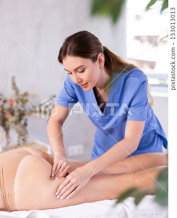Woman does massage of buttocks Woman does massage of buttocks 133013013