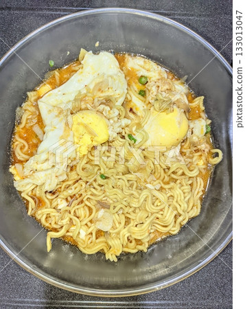Delicious Indomie kuah with rich, savory broth and springy noodles, creating a warm and comforting meal. Perfect for a quick, satisfying dish with bold flavors and aromatic spices! Delicious Indomie kuah with rich, savory broth and springy noodles, creating a warm and comforting meal. Perfect for a quick, satisfying dish with bold flavors and aromatic spices! 133013047