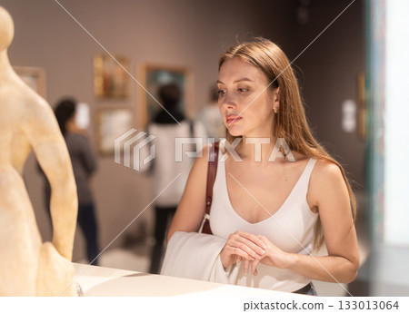 Girl view sculpture in museum hall 133013064