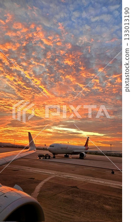 A stunning view through an airplane window, showcasing clear skies and fluffy clouds. The perspective captures the beauty of travel and the freedom of soaring above the earth. A stunning view through an airplane window, showcasing clear skies and fluffy clouds. The perspective captures the beauty of travel and the freedom of soaring above the earth. 133013190