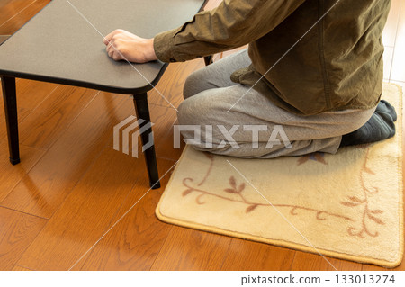 Sit upright on a carpet on the floor 133013274