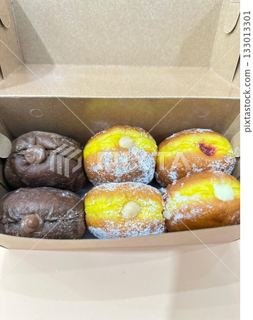 Bomboloni, soft Italian doughnuts filled with creamy custard or jam, dusted with powdered sugar. Fluffy and indulgent, they’re a perfect sweet treat, enjoyed fresh and warm with every bite. 133013301