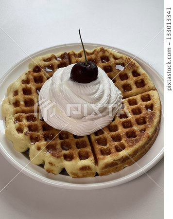 Crispy, golden waffles topped with creamy ice cream, creating a perfect balance of warm and cold, crunchy and smooth. A delightful dessert or breakfast treat, with toppings like fruits or syrup. Crispy, golden waffles topped with creamy ice cream, creating a perfect balance of warm and cold, crunchy and smooth. A delightful dessert or breakfast treat, with toppings like fruits or syrup. 133013341