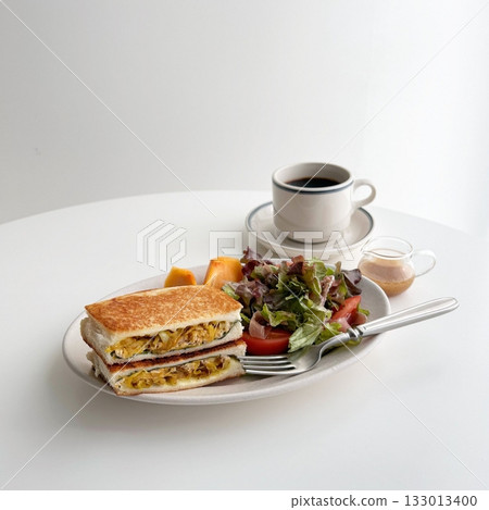 A delightful brunch spread featuring a mix of savory and sweet dishes, including fresh pastries, eggs, seasonal fruits, and a hot beverage. A perfect mid-morning indulgence. 133013400