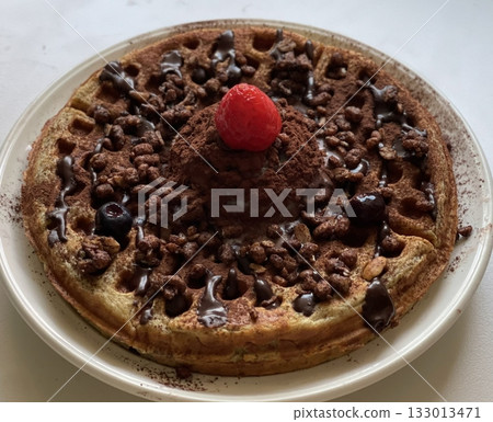 Crispy, golden waffles topped with creamy ice cream, creating a perfect balance of warm and cold, crunchy and smooth. A delightful dessert or breakfast treat, with toppings like fruits or syrup. 133013471