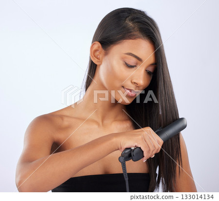 Natural, woman or hair straightener in studio for beauty self care or style treatment on white background. Face, Indian girl model or salon spa equipment for ironing in grooming routine for styling 133014134