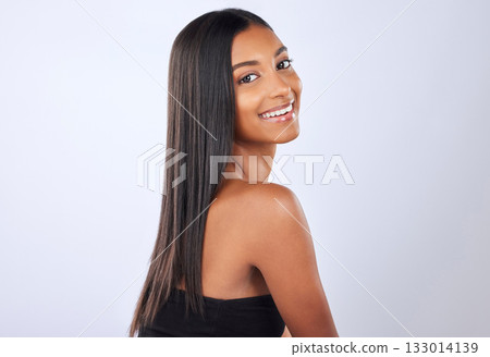 Portrait, beauty and Indian woman with hair care, texture and happiness against grey studio background. Face, female and lady with cosmetics, luxury and salon treatment for shine, glow and self care 133014139