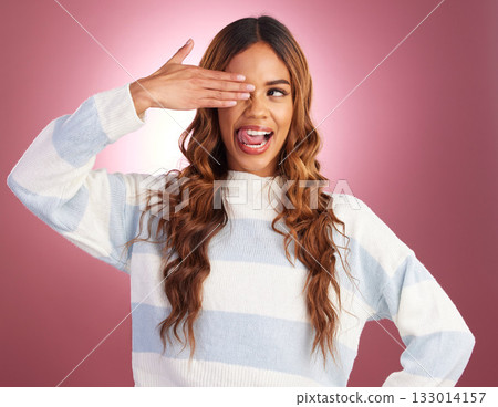 Hand, tongue out and woman in studio, silly and having fun against red background. Face, emoji and gen z girl model posing, young and confident, playful and goofy, casual and comic while isolated Hand, tongue out and woman in studio, silly and having fun against red background. Face, emoji and gen z girl model posing, young and confident, playful and goofy, casual and comic while isolated 133014157