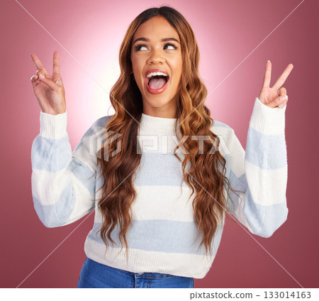 Happy hispanic woman, smile on face and peace sign hands, happy lifestyle celebration on pink background. Happiness, freedom and excited girl in studio with winning hand gesture, v symbol or emoji. 133014163