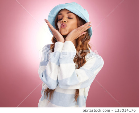 Fashion, fun and woman with kiss, freedom and happiness against pink studio background. Latino female, lady and casual outfit with confidence, lips and gesture for kiss for joy, cheerful and happy 133014176