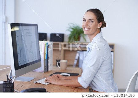 Portrait, happy woman and computer with graphs, data analysis and financial statistics. Female worker typing at desktop for business research, analytics and planning infographics, kpi review or sales 133014196