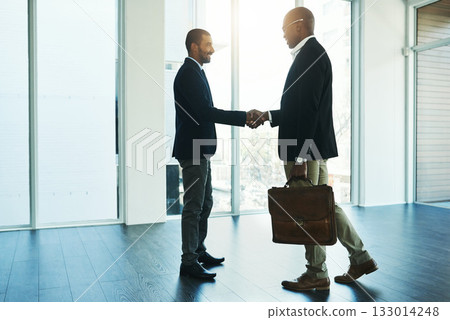 Handshake, partnership and travel for business men in office for onboarding, collaboration and agreement. Corporate, teamwork and male lawyers shaking hands for thank you, welcome and contract deal 133014248