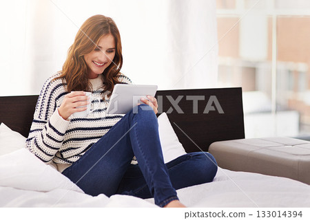 Relax, coffee and tablet with woman on bed for social media, communication and digital. Internet, technology and website with female person reading online at home for ebook, streaming and happiness Relax, coffee and tablet with woman on bed for social media, communication and digital. Internet, technology and website with female person reading online at home for ebook, streaming and happiness 133014394