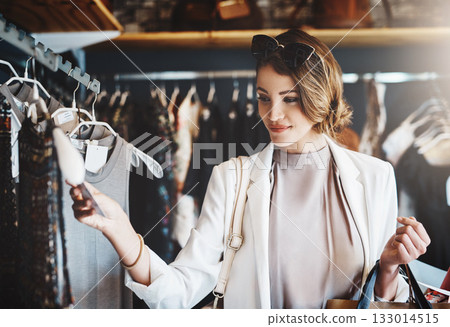 Shopping, fashion and woman with a sale, boutique and discount items with retail, client and luxury. Female person, customer and shopper with price tag, store and outfit choice with clothes selection 133014515