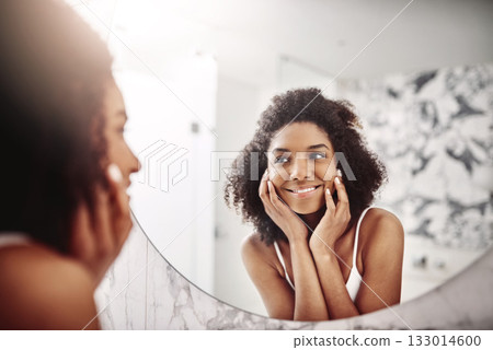 Woman, skincare and dermatology in mirror with a smile in the bathroom for wellness at a hotel. Model, happy and beauty with skin, glow for self care in the morning at an apartment for healthy face. Woman, skincare and dermatology in mirror with a smile in the bathroom for wellness at a hotel. Model, happy and beauty with skin, glow for self care in the morning at an apartment for healthy face. 133014600